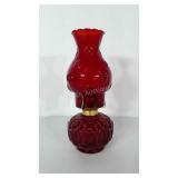 Red glass oil lamp. Stands 12" tall. One chip in