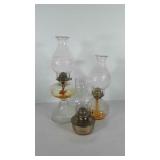 Three oil lamps, 11"- 18" h, two have "Home Sweet