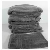 Five bath towels and one hand towel all made by