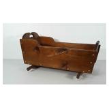 Wooden doll cradle.  Inside measures 11x21 inches