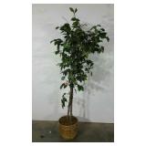 Artificial tree in basket with lights.