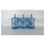 Three empty Dear Park 5 gallon water jugs with