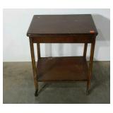 Swivel top fame table on wheels with under shelf.