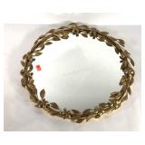 Round wall mirror with gold painted leaves and
