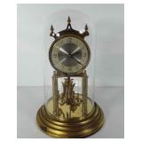 Brass clock with glass dome, made in Germany