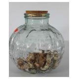 Green decor jar 1/3 full of wine corks,