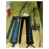 Group of three grease guns