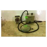 Two electric timers and magnifying lens