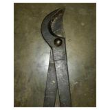 Old set of tree limb loppers, one handle has a