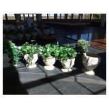 Six concrete planters with artificial greenery