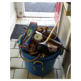 Two big blue muck buckets and filled with tools,