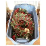 Rubbermaid tote with Christmas wreaths, located