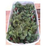 Rubbermaid tote with Christmas garland, located