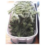 Large storage tote with artificial Christmas