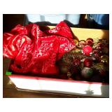 Box with Christmas tree skirt and bulbs, located