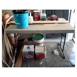 4 ft poly Lifetime folding table shows shop use