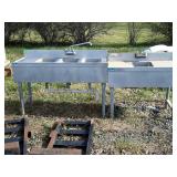 Two stainless commercial sinks, single and