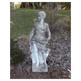 Concrete statue of man archer with dog