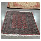 Red blue and black wool rug wit Dimond border and