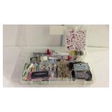 Craft supplies in plastic container with hinged
