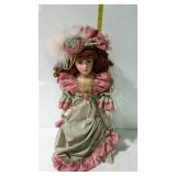 16" porcelain doll in green dress with rose trim,