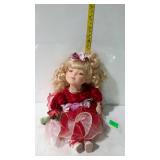 8" tall seated music box doll in red dress -
