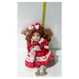 8" tall seated music box doll in red & white dress