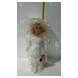16" porcelain doll in white dress with peach trim,