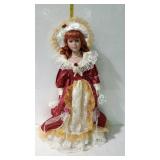 22" porcelain doll in rust and cream colored dress