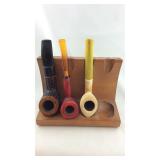 pipe stand with three smoking pipes