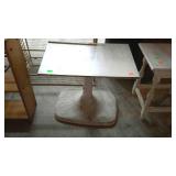 Swivel top table with pedestal base and laminated