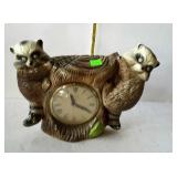 Electric clock with raccoon design