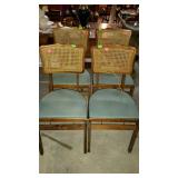 Set of four folding chairs with padded green