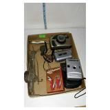 Flat with cameras, pocket knives, whistles etc