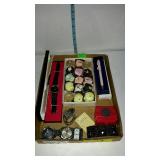 Flat with sewing pin cushions, wrist watches,
