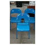 Three blue folding chairs