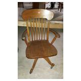 Wooden desk chair on casters spindle back