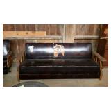 Oak framed sofa with wagon wheel side design and
