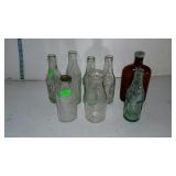 Collection of eight bottles. Milk, soda and