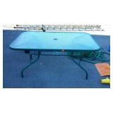 Green glass top, patio table, measures 60 inches