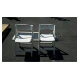Two plastic folding chairs