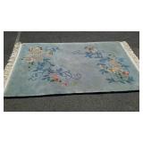 Small area rug with sculpted floral design on