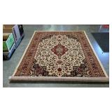 Area rug. 63" × 91". Red and tan. Like new