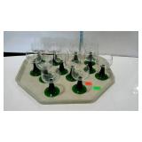 Glass - set of twelve green pedestal based clear