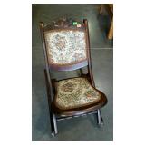 Folding sewing room rocker. Has carved rose top.