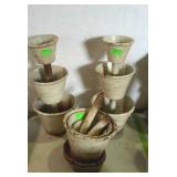 Three iron triple tiered planters with saucers.