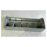 Galvanized divided hardware tote with handle.