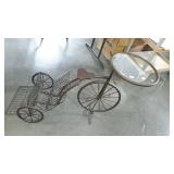 Metalwork plant stand in tricycle form. Basket on