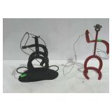 Two metal sculptures made from horse shoes, made