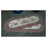 Two oval braided throw rugs with candy cane design